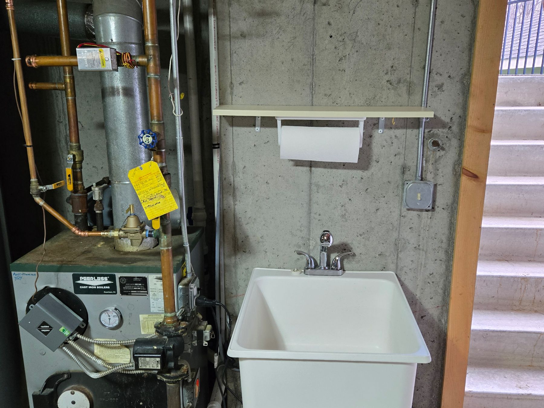 Utility sink and boiler in a basement