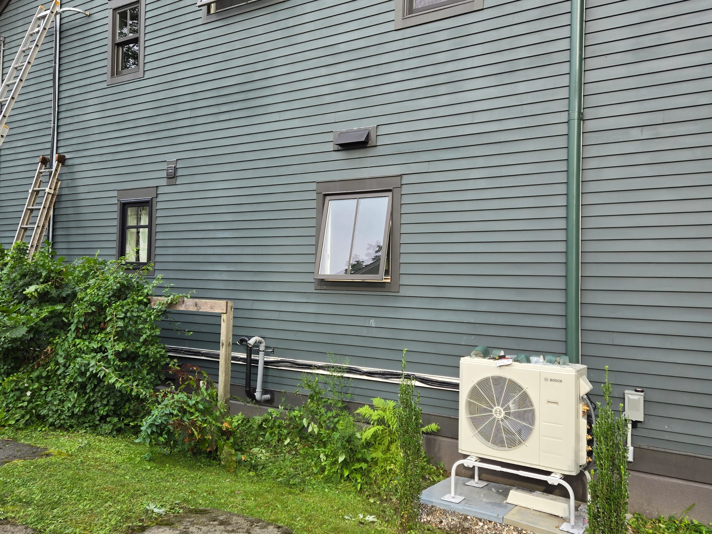 Exterior mini-split condenser unit mounted by Primrose